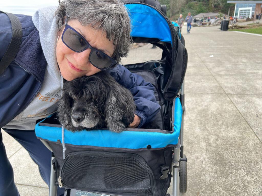 Judy hugging our dog Ryan in his stroller.