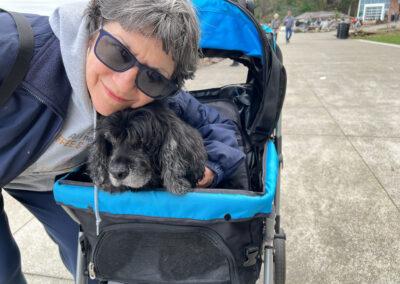 Judy hugging our dog Ryan in his stroller.