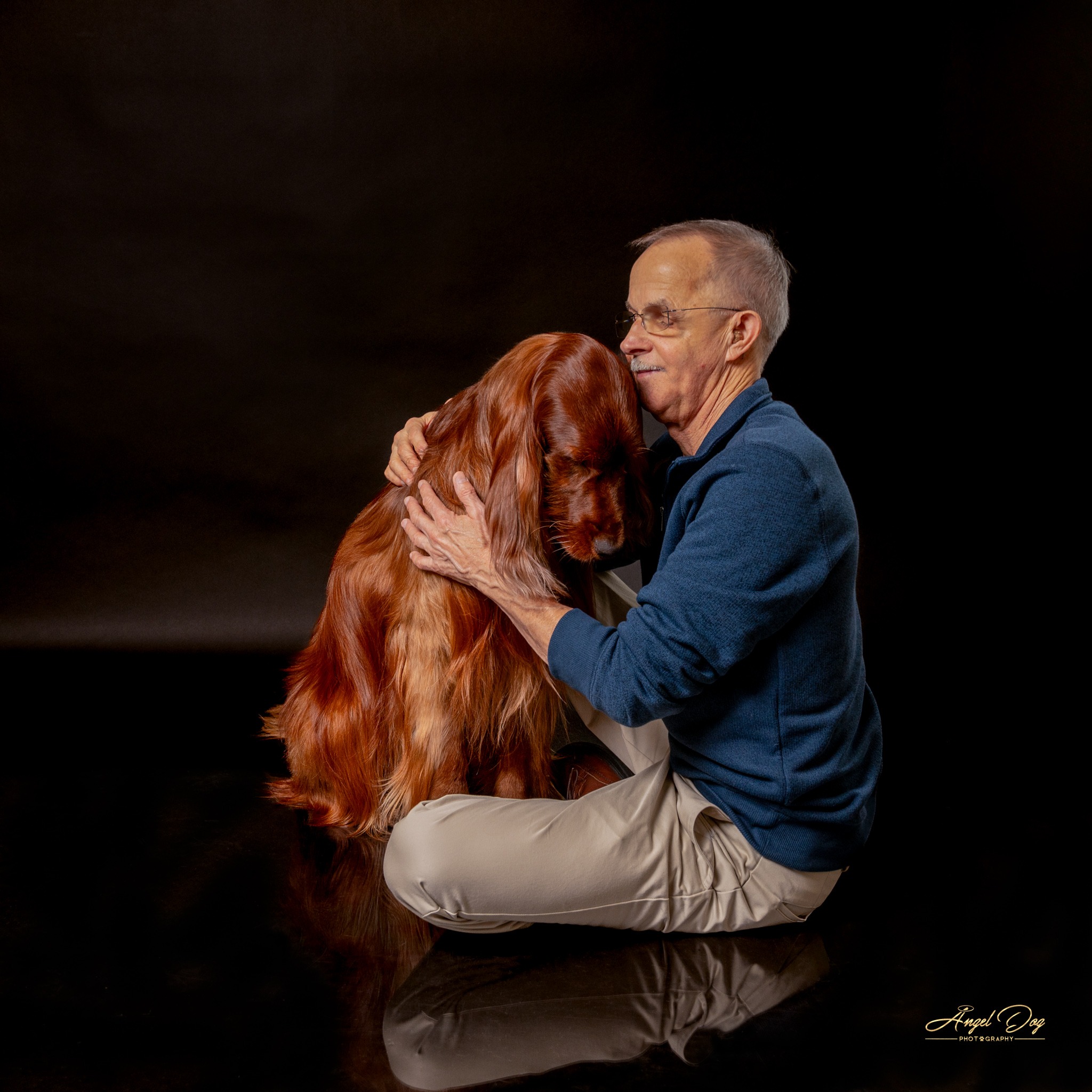 Irish Setter leaning into his person. He is getting a hug.